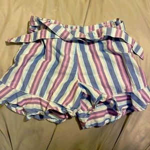 Striped shorts with ruffle bottoms and belt.